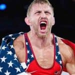 Kyle Dake celebrating with a USA flag around his shoulders