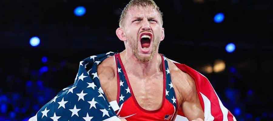 Kyle Dake celebrating with a USA flag around his shoulders